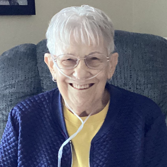 Dora sitting wearing nasal cannula