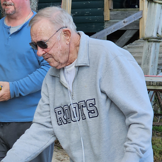 man wearing oxygen playing cornhole