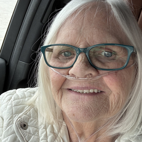 Woman in car wearing nasal cannula for oxygen
